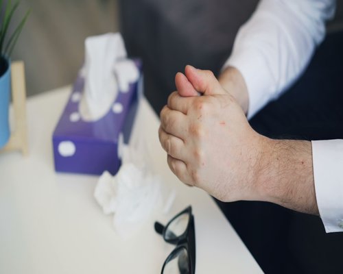 Hands folded on a desk during a quick restorative break