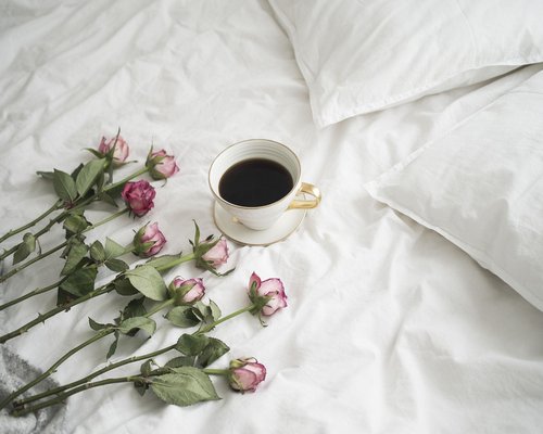 A brief pause taking coffee off screen during a workday